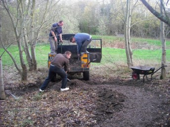 Shifting material onto the pond corner.