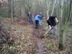 Raking a mountain bike trail.