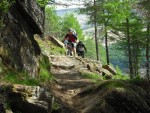 Riders ascending rocks.