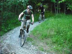 Two riders on mountain bike trail.