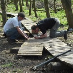 Building wooden mountain bike trail section.