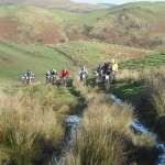 Mountain bike riders on a hill.