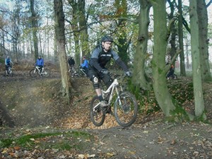 Rider jumping out of bomb hole in Forest of Dean.