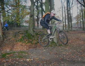 Rider jumping out of bomb hole in Forest of Dean.