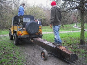 Towing a log with a Land Rover.