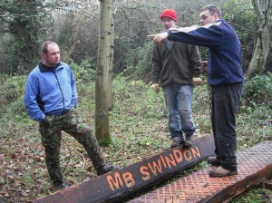 People standing on logs discussing things.