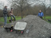 People loading wheel barrows.