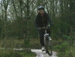 Woman riding mountain bike.