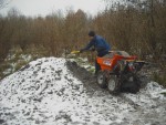 Large pile of gravel and muck truck.