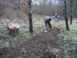 Two trail builders digging.