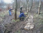 Three trail builders working on trail.