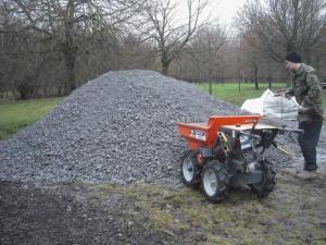 Pile of gravel and power barrow.