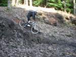 Mountain bike rider going down steep ramp.