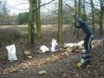 Man smashing rubble with sledge hammer.