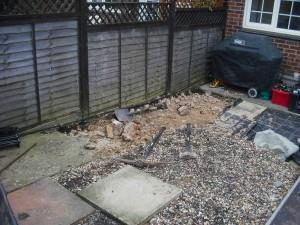 Garden with concrete path being broken up.