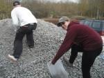 Filling sacks with gravel.