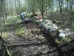 Digging out muddy trail.