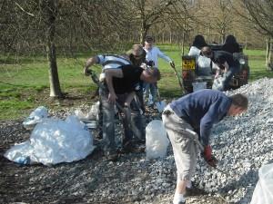 Group of volunteers moving gravel.