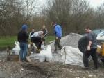 Filling bags with gravel.