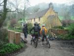 Mountain bike riders stopped on a road.