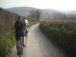 Mountain bike rider on road in Cotswolds.