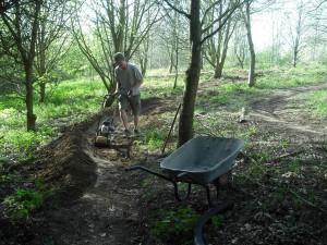 Building a berm on trail.