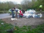 Volunteers loading gravel into sacks at mountain bike trail.