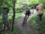 Photographers and riders on mountain bike trail.