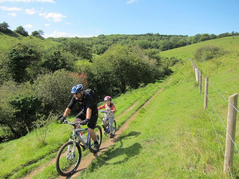 Mountain bike rider and tag along bike near Castle Combe.