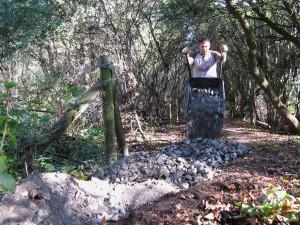 Tipping gravel from wheel barrow.