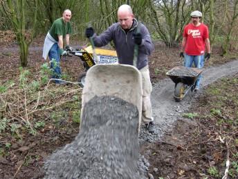 Shifting limestone chippings at a trail build day.