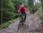 Riding down a muddy track at Crychan Forest.