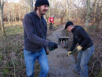 Spreading dust onto new mountain bike trail.