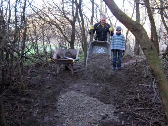 Tipping limestone at a trail build day.