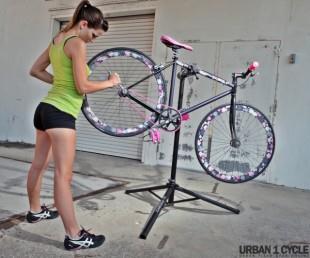 Woman bike mechanic and pink bike.