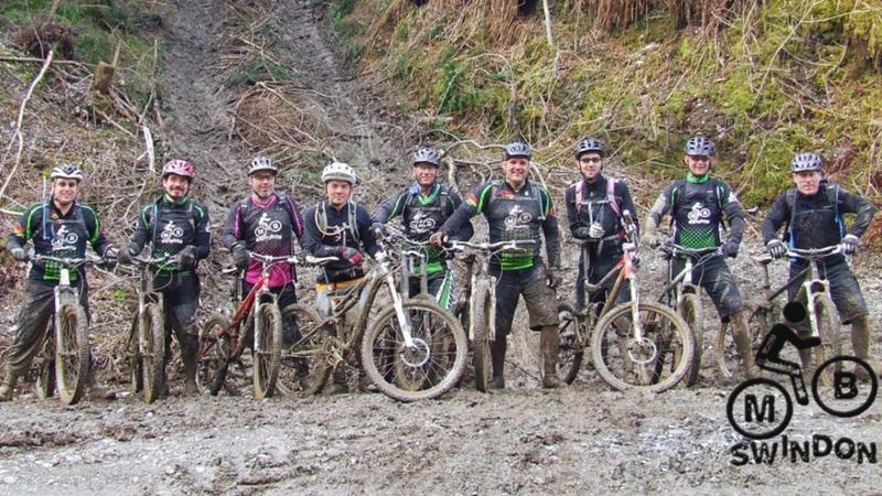 Muddy group of mountain bikers
