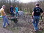 Big society team digging gravel.