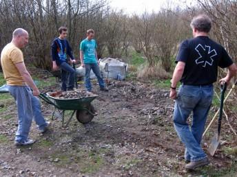 Big society team digging gravel.
