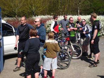 People standing around in a car park.