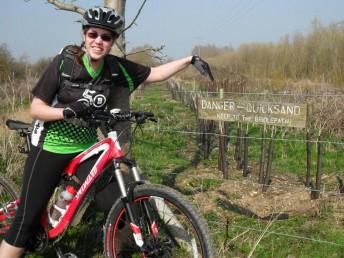 Quicksand sign and women mountain biker.