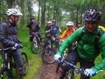 Wet mountain bikers in the Forest of Dean.