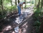 Filling pot holes at mountain bike trail.