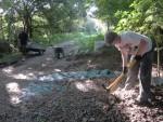 Digging up chippings at mountain bike trail.