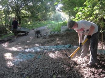 Digging up chippings at mountain bike trail.