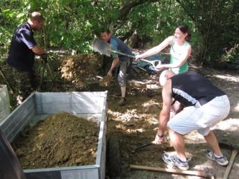 Loading a trailer with mud at a mountain bike build day.