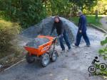 Muc truck and large pile of gravel at mountain bike trail.