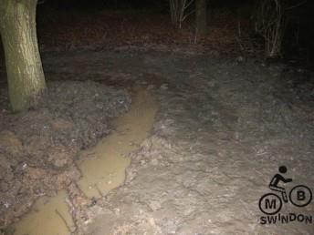 Drainage ditch being dug in the dark.