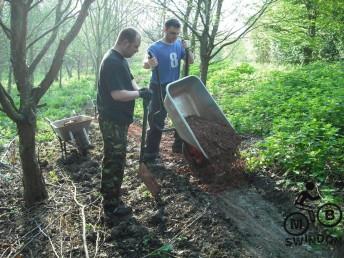 Dumping load from a wheel barrow.