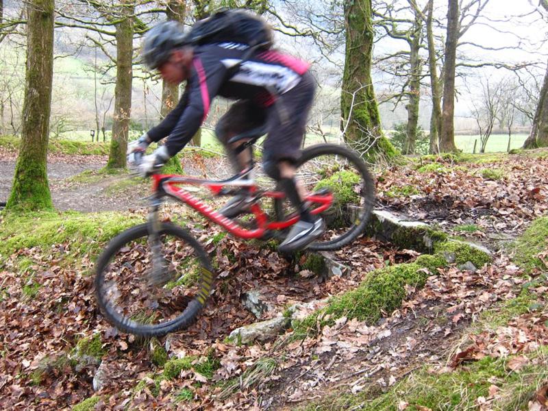 Riding a set of steps on a mountain bike coaching session.