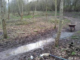 Sunken mountain bike trail. Puddles.